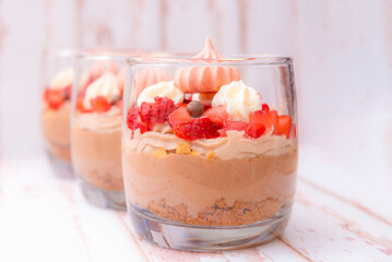Three glasses of homemade chocolate mousse with fresh strawberries