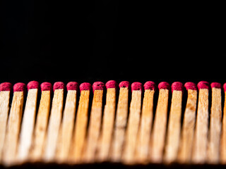 Wooden matches with red sulfur heads on a black background. Fire ignition matches. Matchbox. Red...
