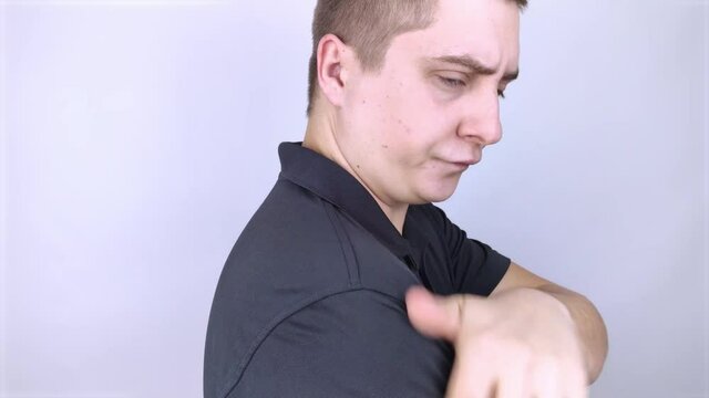 Dandruff on a man's shoulder. Side view of a man who has more dandruff flakes on his black shirt. Scalp disease treatment concept. Discomfort from a fungal infection
