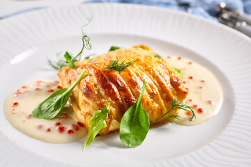 Zander Fish Baked in Dough with Caviar and Cream Sauce. Restaurant food plate on white table....