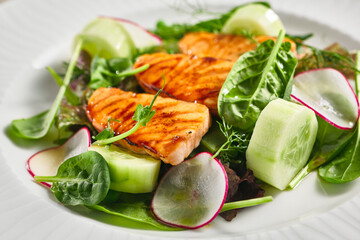 Salmon Salad with Fresh Vegetables. White plate with healthy fish food on wooden table. Healthy, Vegetarian, Restaurant rustic food concept.