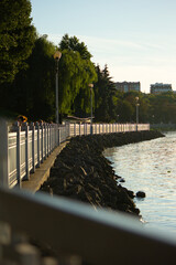 The reservoir is fenced with a fence and a stone embankment