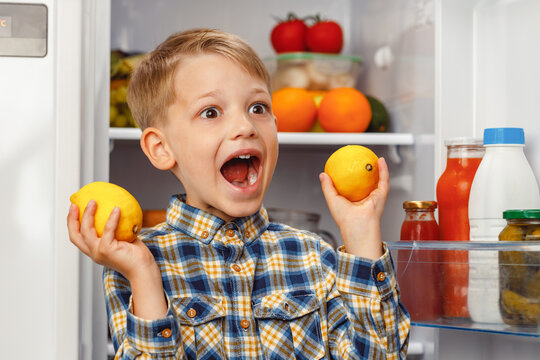 Little Boy Standing Near The Open Fridge