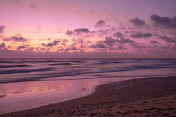 Fototapeta na wymiar Seascape in the early morning. Sunrise on a sandy beach with beautiful sky