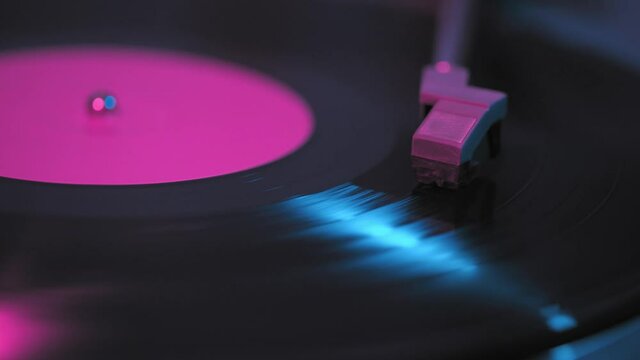 Old retro vinyl record, vintage turntable, neon light.