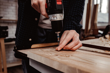 Close up of a carpenter drilling a hole in timber
