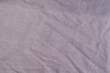 Crumpled light lilac fabric background.