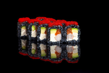 black sushi roll on black background