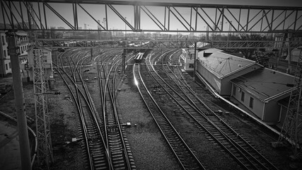 Railway. Industrial retro landscape. Station. Black and white. Metal constructions. Perspective view. Horizontal wallpaper.