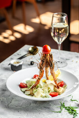 Caesar Salad with Shrimp. Caesar salad with king prawns in a white plate. Restaurant menu, dieting, cookbook recipe