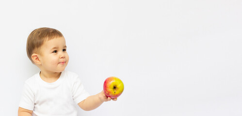 Fototapeta na wymiar Small caucasian two years old boy with big green apple, isolated on white background
