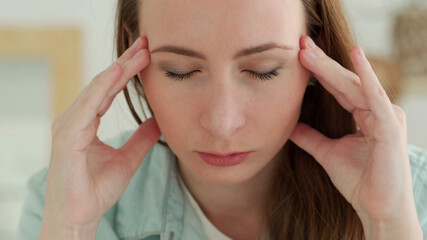 Fototapeta premium Close up of sad tired woman touching her head having headache or depression