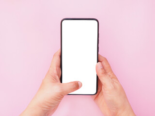 The hand-holding smartphone shows a white screen display on pink background. Top view, flat lay with copy space.