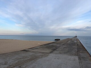 calm sea with sandy shore and gentle sunset