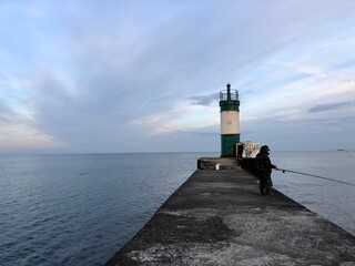 calm sea with beautiful sunset sky and lighthouse