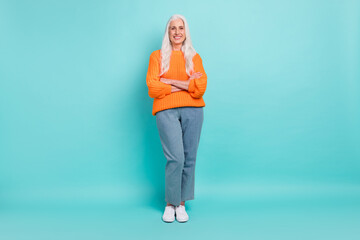 Full length body size view of attractive cheerful grey-haired woman folded arms isolated over teal...