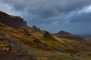 hills, peaks and rocks in scenery of The Quiraing on the Isle of Skye with a sheep in a cloudy day , Scotland