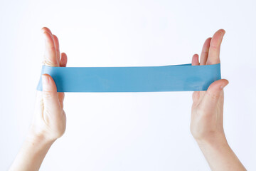 Woman showing a blue rubber band. Sport and healthy active lifestyle concept.
