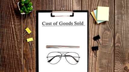 Cost Of Goods Sold form on a wooden table with office tips