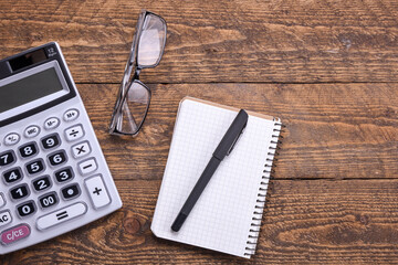 Calculator keypad on a wooden floor background. Top view. Copy space