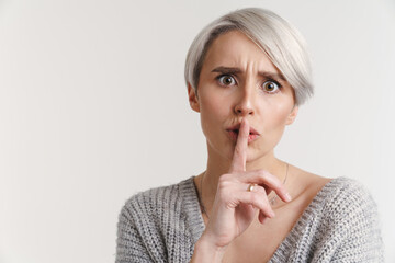 Displeased beautiful silver girl showing silence gesture