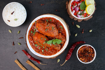 Spicy red Indian Chicken curry tikka masala Chicken leg curry Korma gravy dish Hyderabad India Pakistan . hot non-vegetarian food Indian spices side dish chapati, roti, paratha.