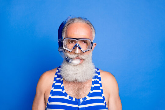 Photo Of Funky Funny Mature Man With Goggles And Snorkeling Prepare To Diving Isolated On Blue Color Background