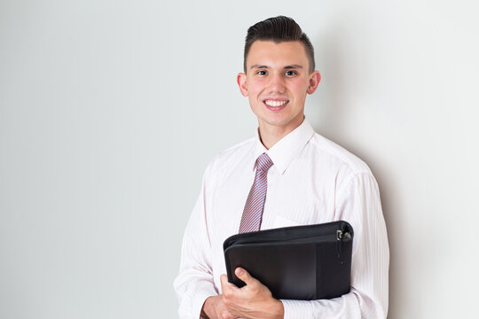 Portrait of a businessman holding a leather folder
