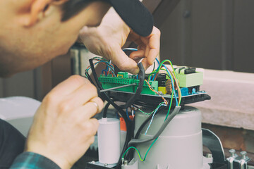 Technician man installing and checking the function of automatic gate