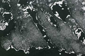Pure spring ice on the lake. The combination of water and ice created wonderful patterns