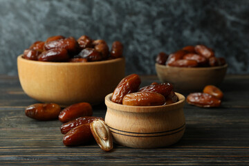 Bowl with dried dates on wooden table