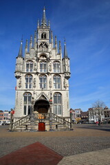 The impressive gothic styled Stadhuis (town hall, dated from 1450), located on the Markt (main Square) and surrounded by historic houses in Gouda, South_Holland, Netherlands