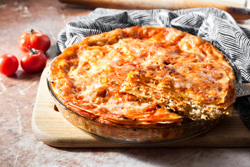 Homemade lasagna in round glass baking dish