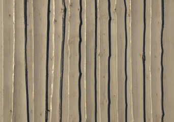 Texture of gray surface from rough processing boards. Light falls from the evening sun.