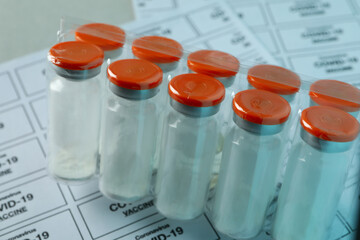 Concept of Covid - 19 vaccination with vials of powder vaccine