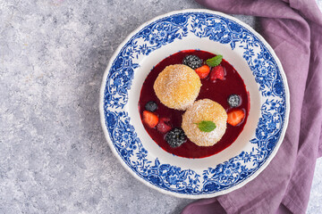 Sweet dumplings with berry sauce and fresh berries