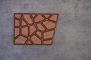 sweet delicious chocolate lies on dark gray stone background