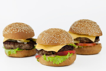 Group of burgers isolated on light background, background out of focus