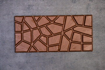 sweet delicious chocolate lies on dark gray stone background