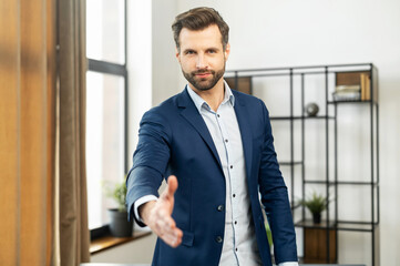 Confident businessman dressed in suit, handshake for teamwork of business merger and acquisition,...
