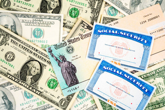 Us social security cards, stimulus check and dollar bills.