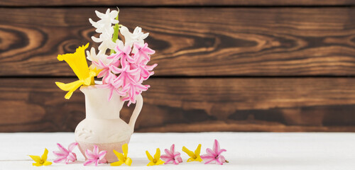 spring  flowers in vase on wooden background