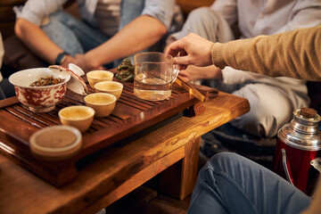 Obraz na płótnie Canvas Young man performing traditional tea ceremony in cozy cafe