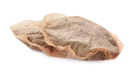 Two used tea bags on white background