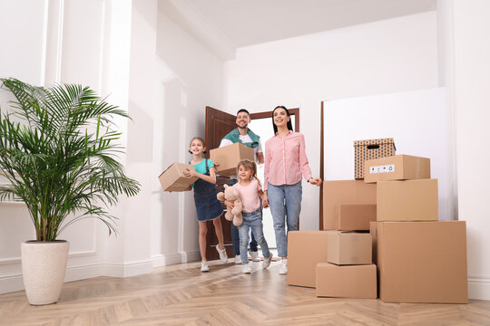 Happy family with children moving into new house