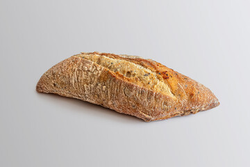 Rye grain bun with flax and sesame seeds, on a light background