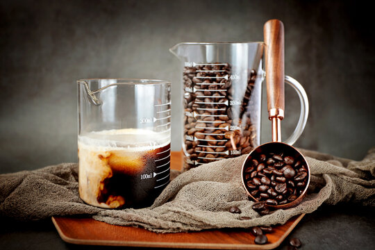Roasted coffee beans and coffee in a beaker