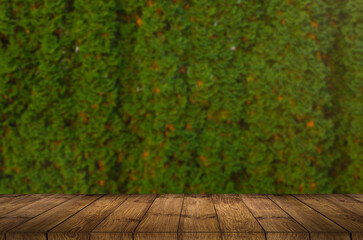 Empty wooden table with garden bokeh for a catering or food background with a country outdoor theme, mock up for display of product.