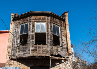 Abandoned old wooden home exterior view during the sunny spring day.
