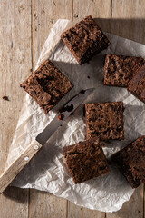 Homemade pieces of brownies on wooden table	